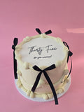 White and black ribbon cake